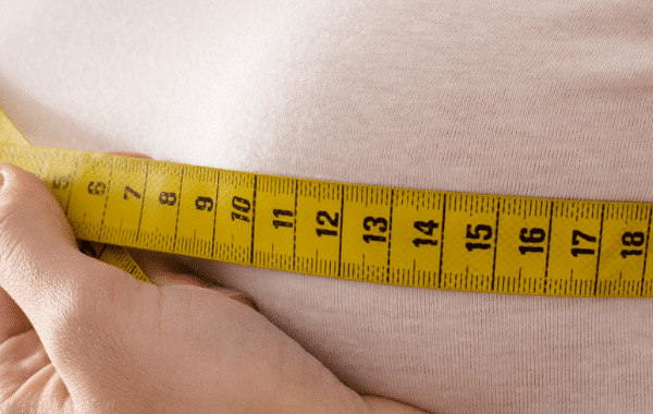 lady measuring the size of her breasts