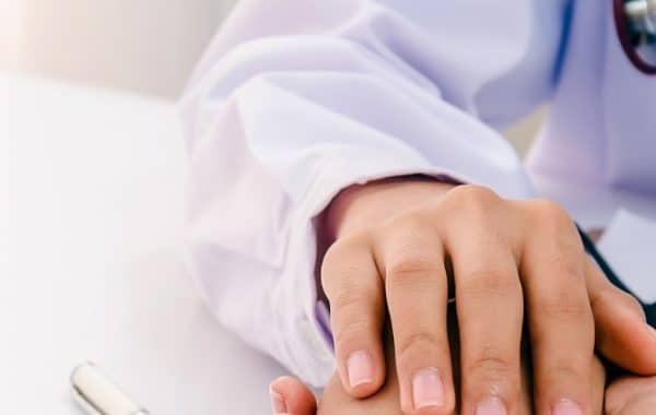 female doctor holding a person's hand