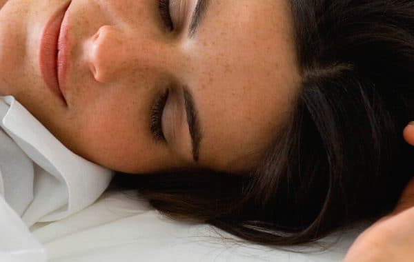 happy woman lying in bed