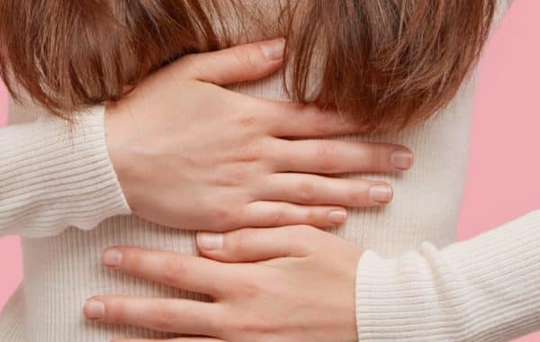 young woman holding her stomach