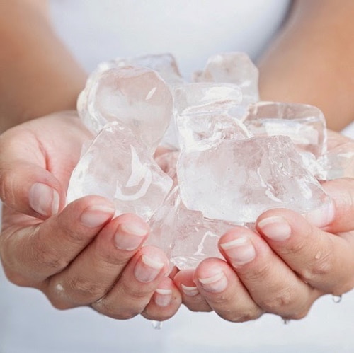 woman holding ice cubes