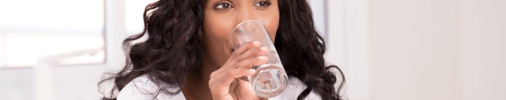 woman drinking a glass of water
