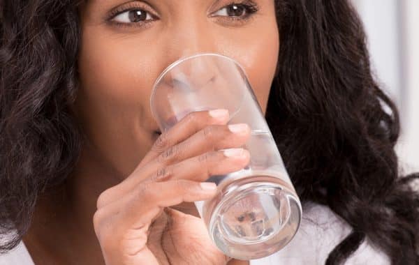 woman drinking a glass of water