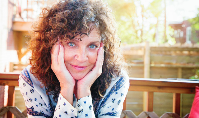 relaxed mature woman portrait balcony head in hands