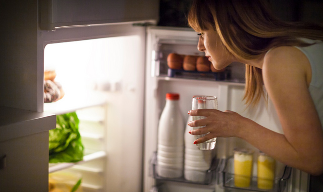 young woman having a midnight snack