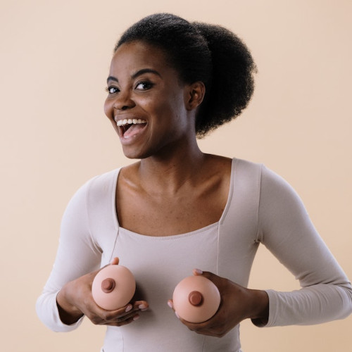 woman holding boob-shaped cupcakes