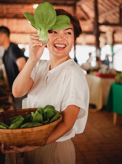 woman holding green vegetable
