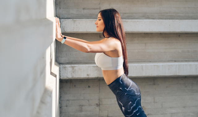 fitness woman doing standing wall push-ups