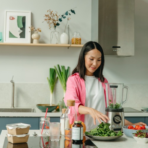 woman in kitchen full of veggies