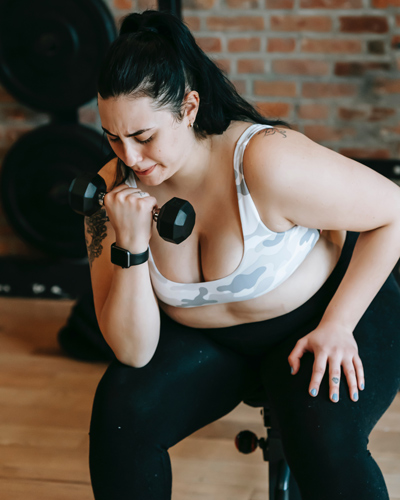 woman exercising with dumbbell